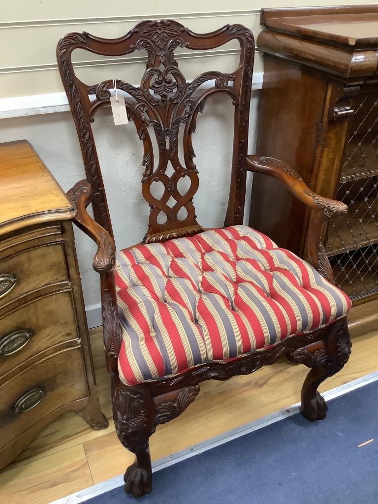 A pair of George III style Irish design mahogany elbow chairs